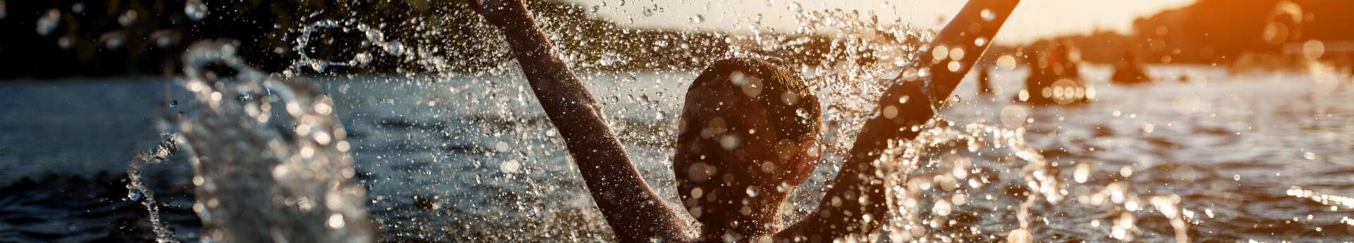 child swim in lake or river and have fun with drops.