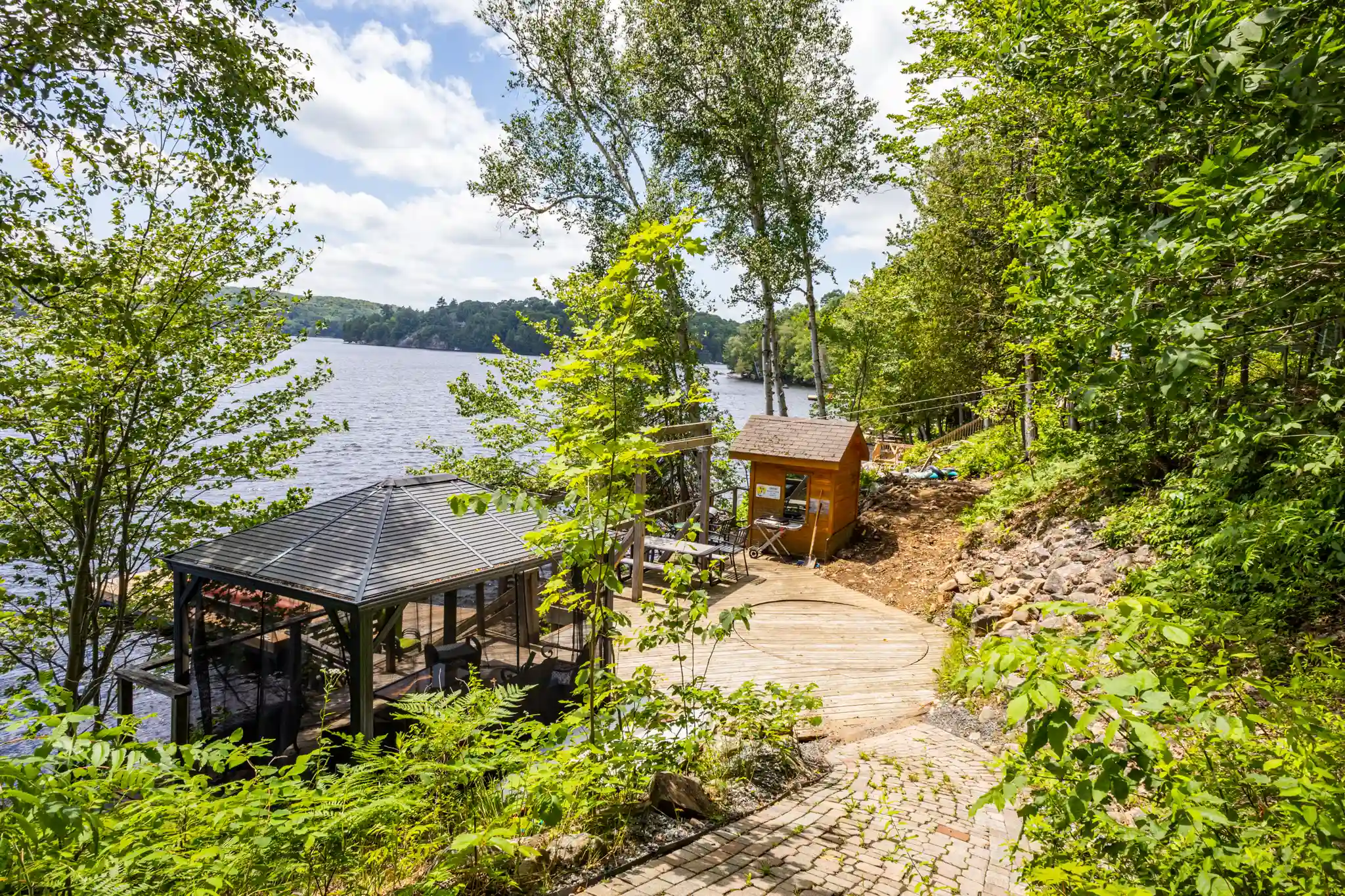 Lakeside cottage setting with dock, gazebo, and natural surroundings similar to a Sterling Point vacation rental