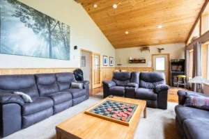 Cozy Muskoka cottage living room with comfortable seating and recreation area inspired by Sterling Point